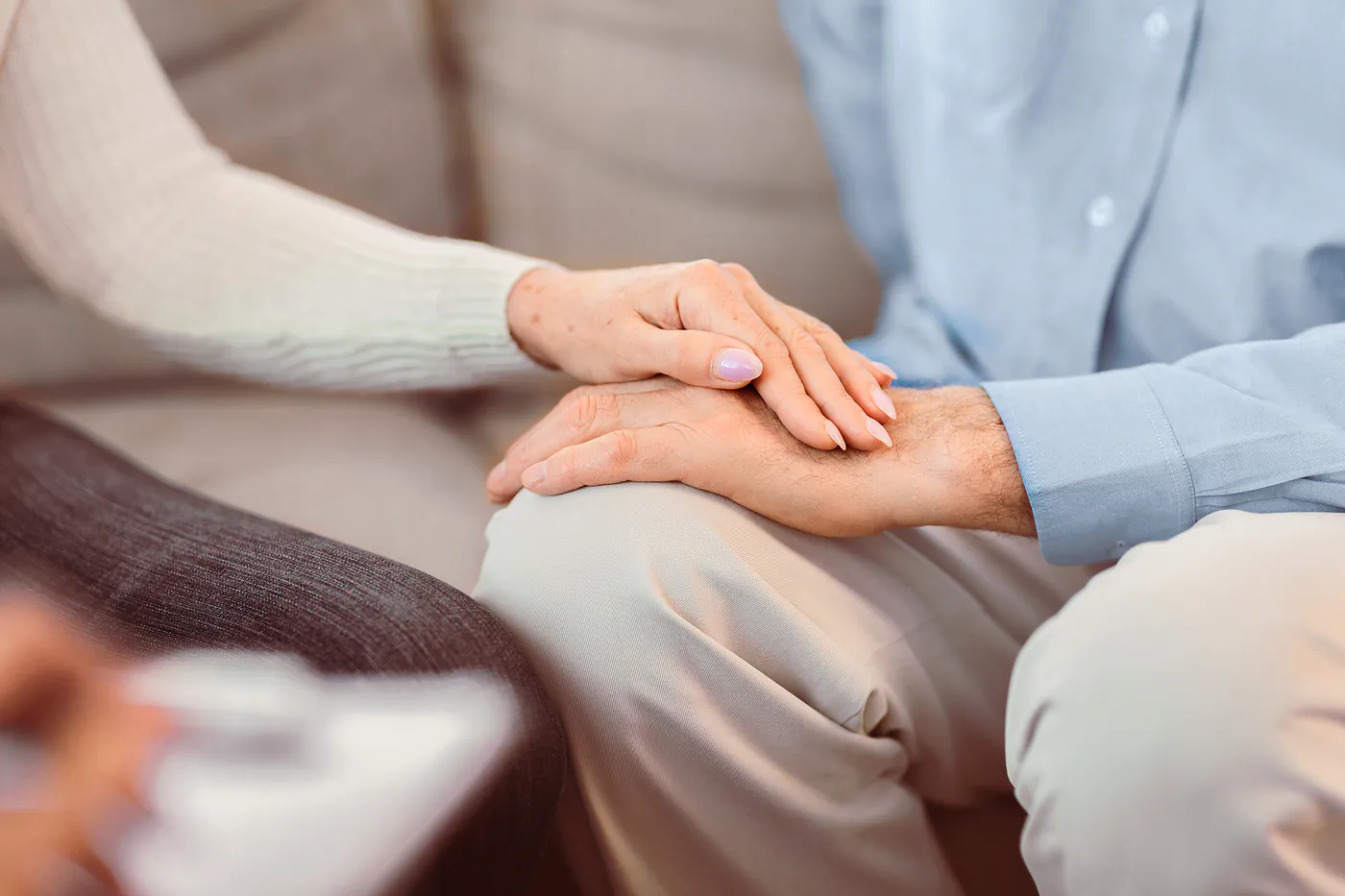 Couple holding hands in comfort during a counseling session at Together Works in Leland, NC