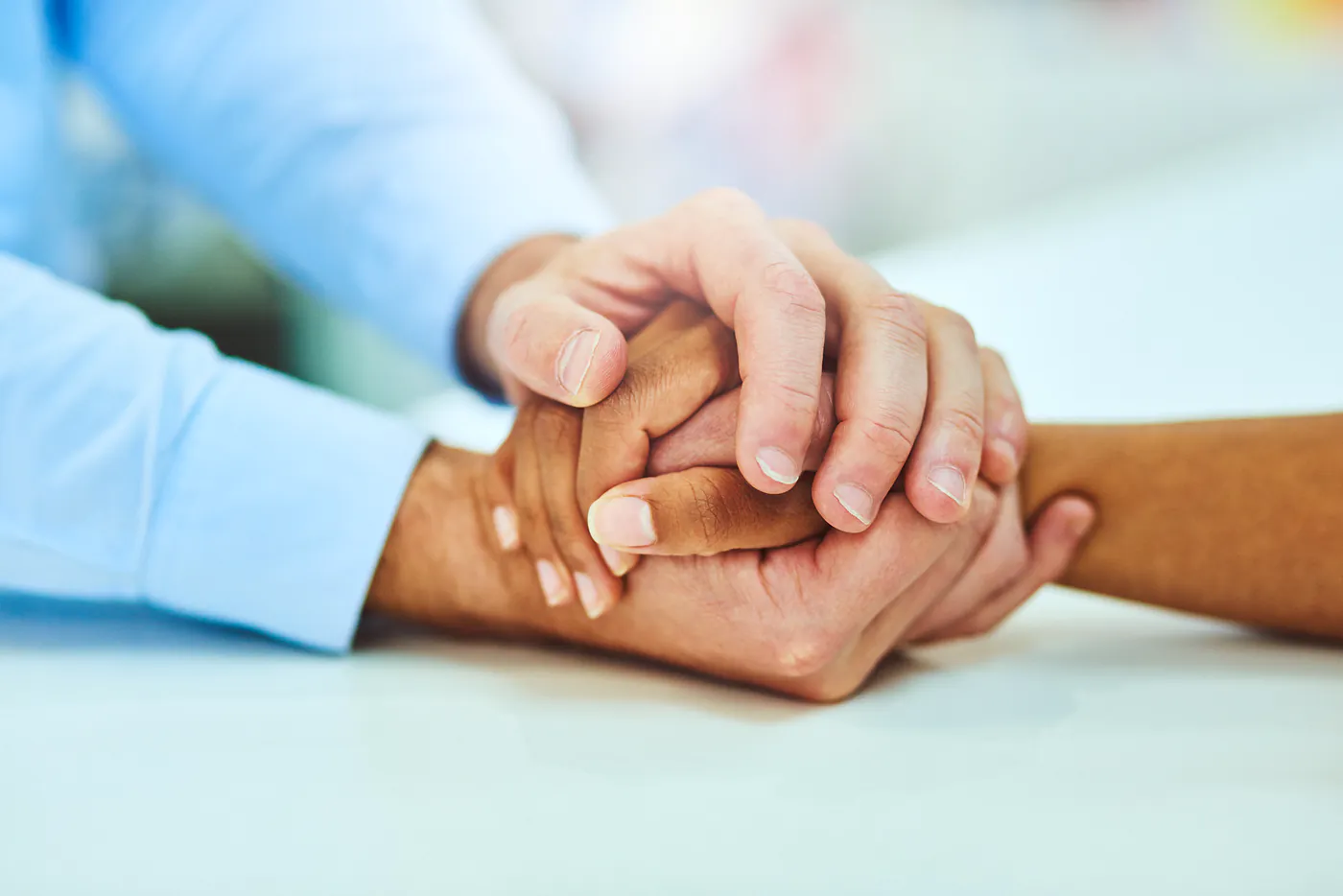 Therapist holding a client’s hands in support during a counseling session at Together Works in Leland, NC